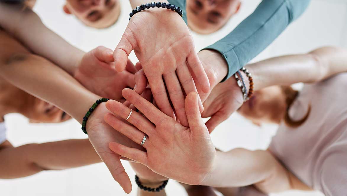 Promoting Eduction - community with hands together